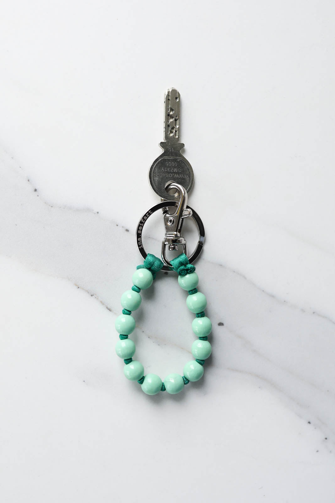 Key ring beads short in pastel green/green